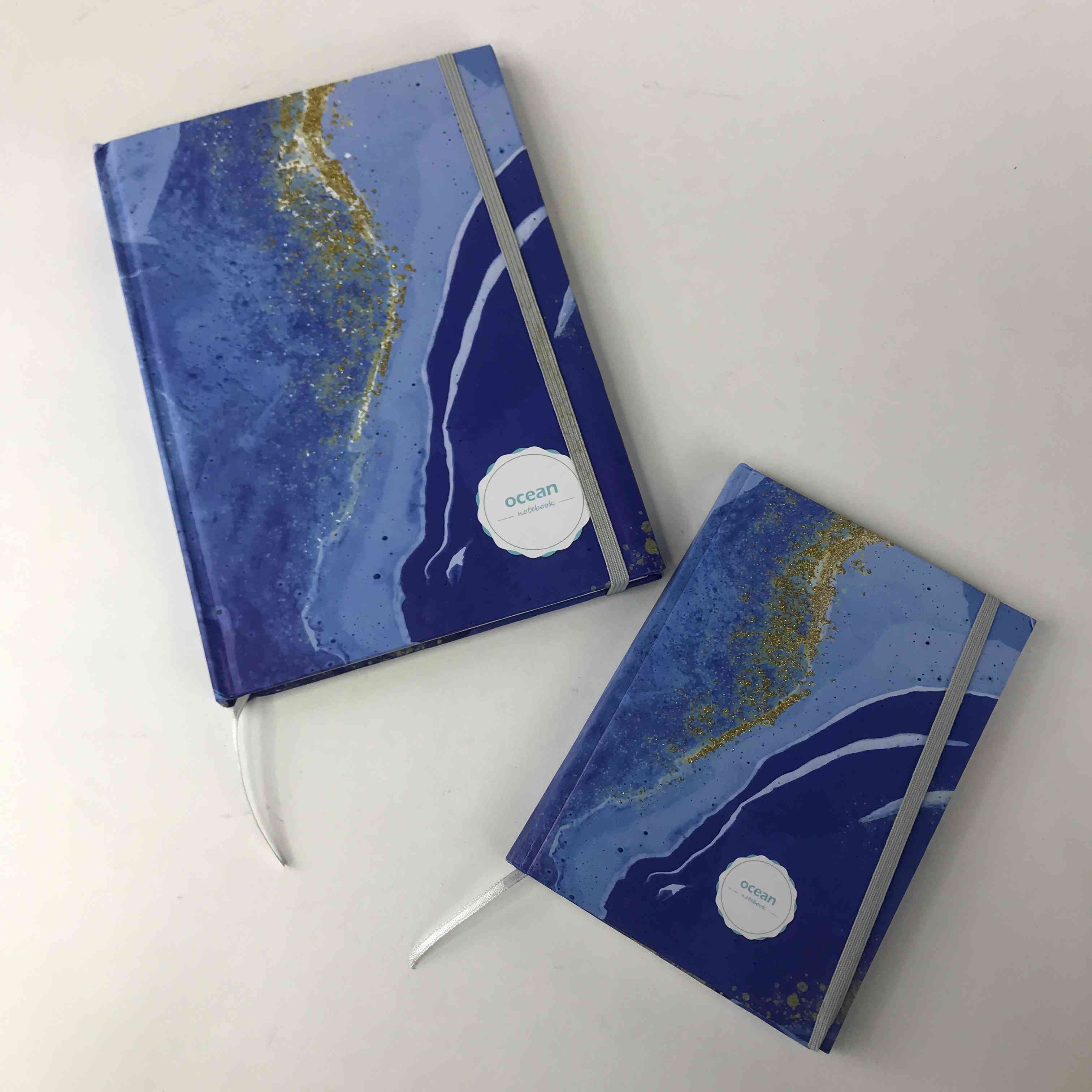 Carnet relié à fil océan estampé à l'or